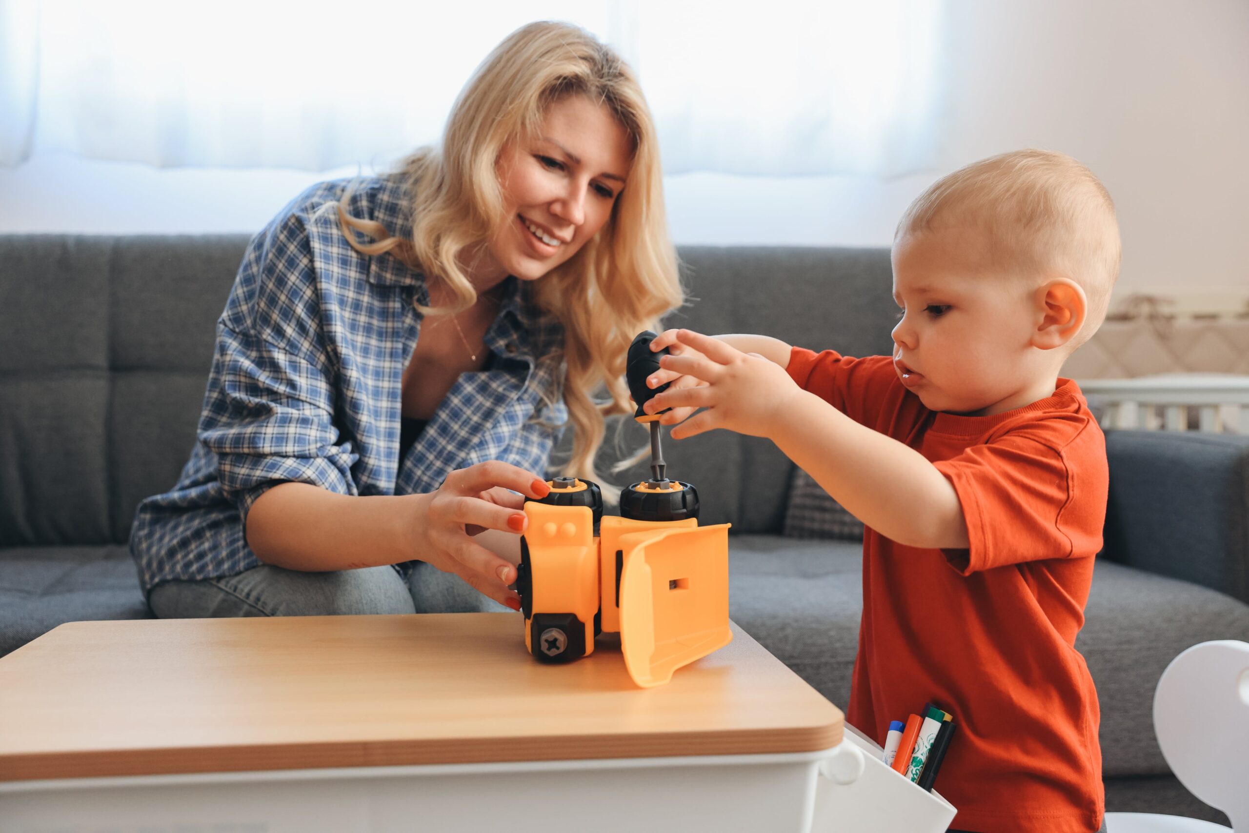 mother-and-son-playing-with-construction-truck-toy