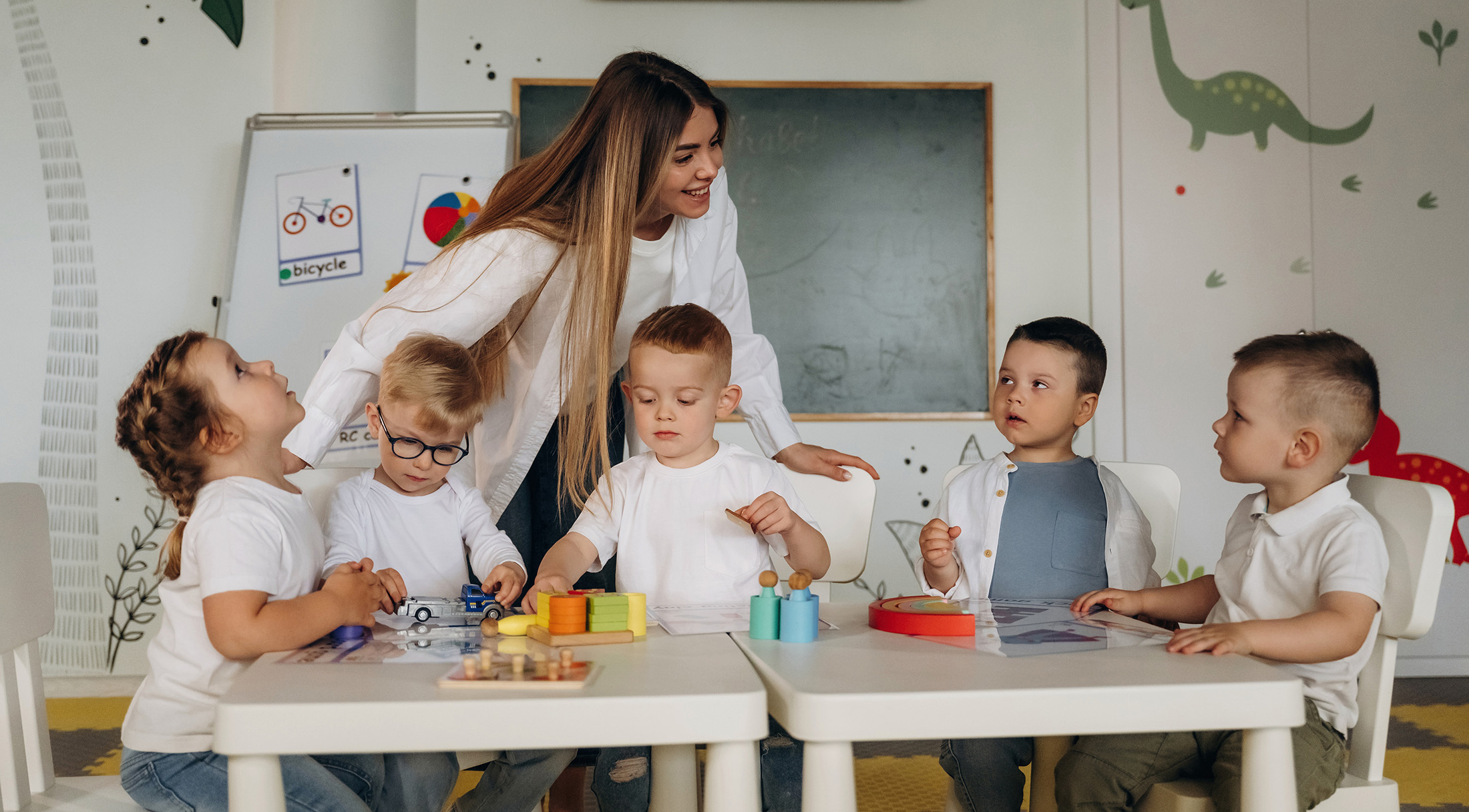 Colorful toys, educational game. Children in kindergarten with their teacher